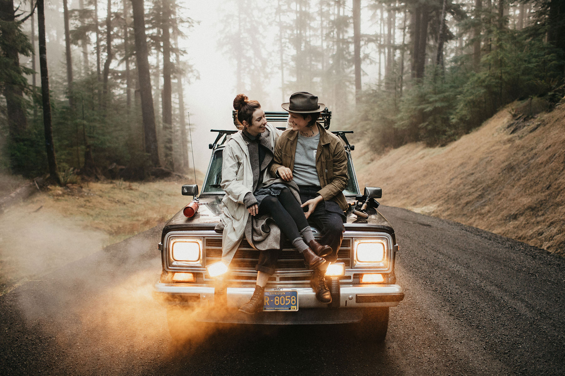 A couple sitting on an old Jeep. Edited with Analog Film Lightroom Presets by meridian.