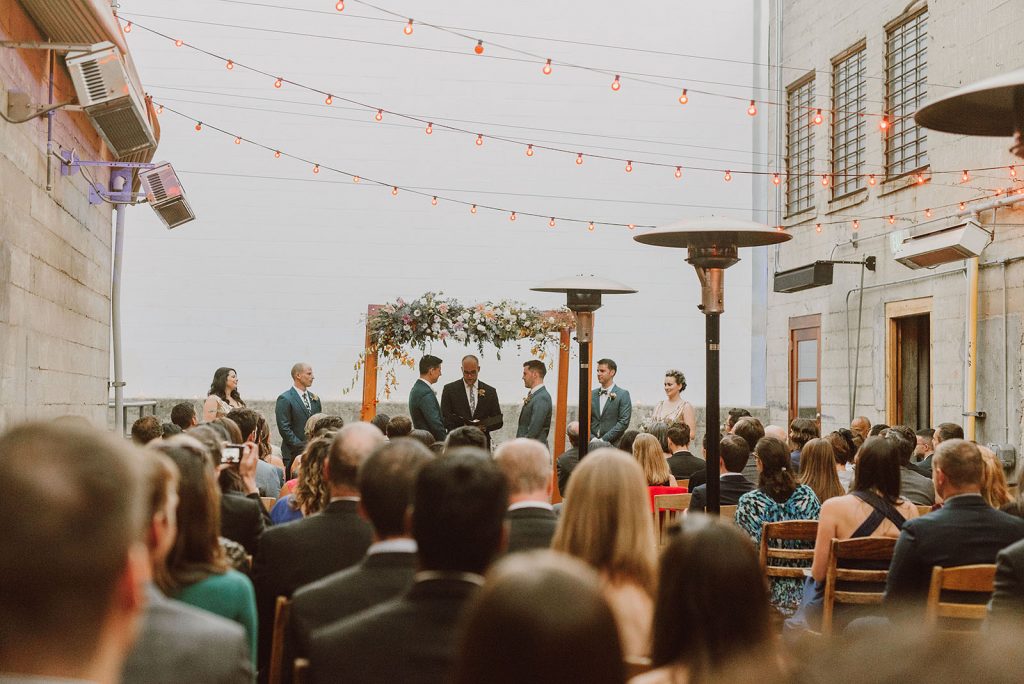 A wedding couple is getting married at the terrace of the Foreign Cinema, one of the San Francisco wedding venues.